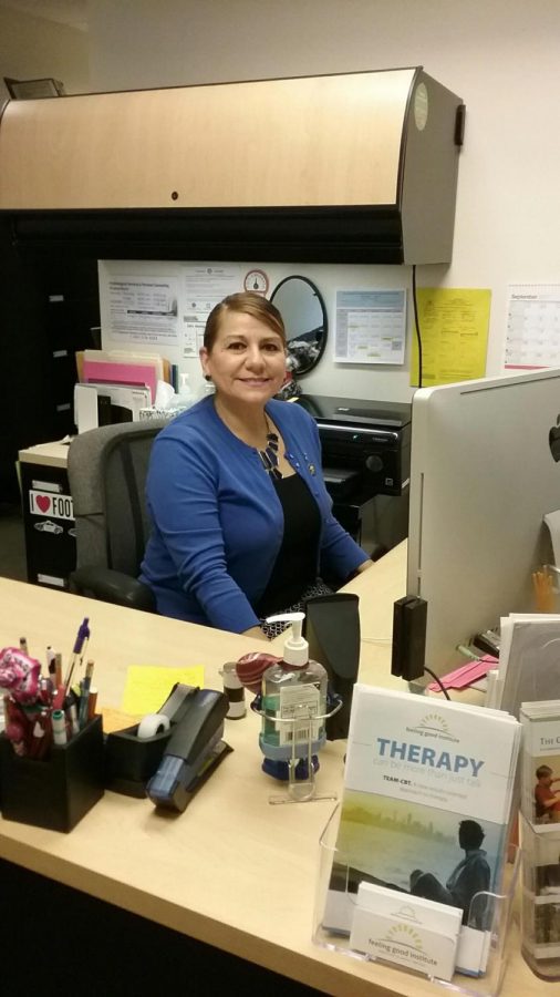 Administrative assistant, Patricia Meza Parada, diligently works at her desk in the Psychological Services and Personal Counseling Center