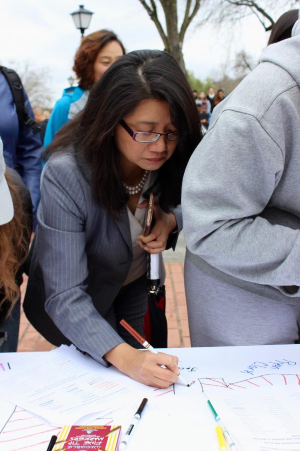 President Nguyen signs posters during a National School Walkout event at Foothill College.