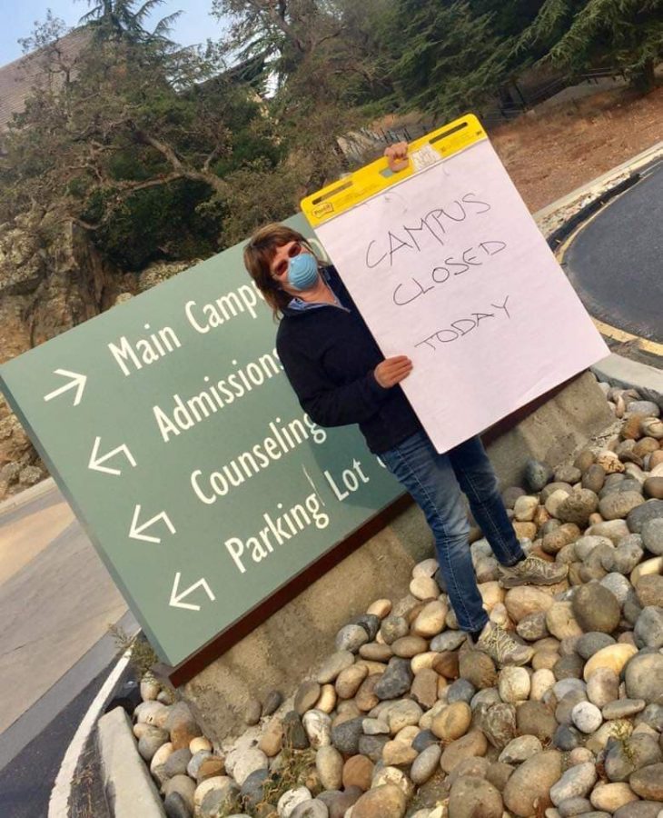 Director of Facilities Branda Davis-Visas stands in front of Foothill College alerting
 incoming cars of the campus closure.