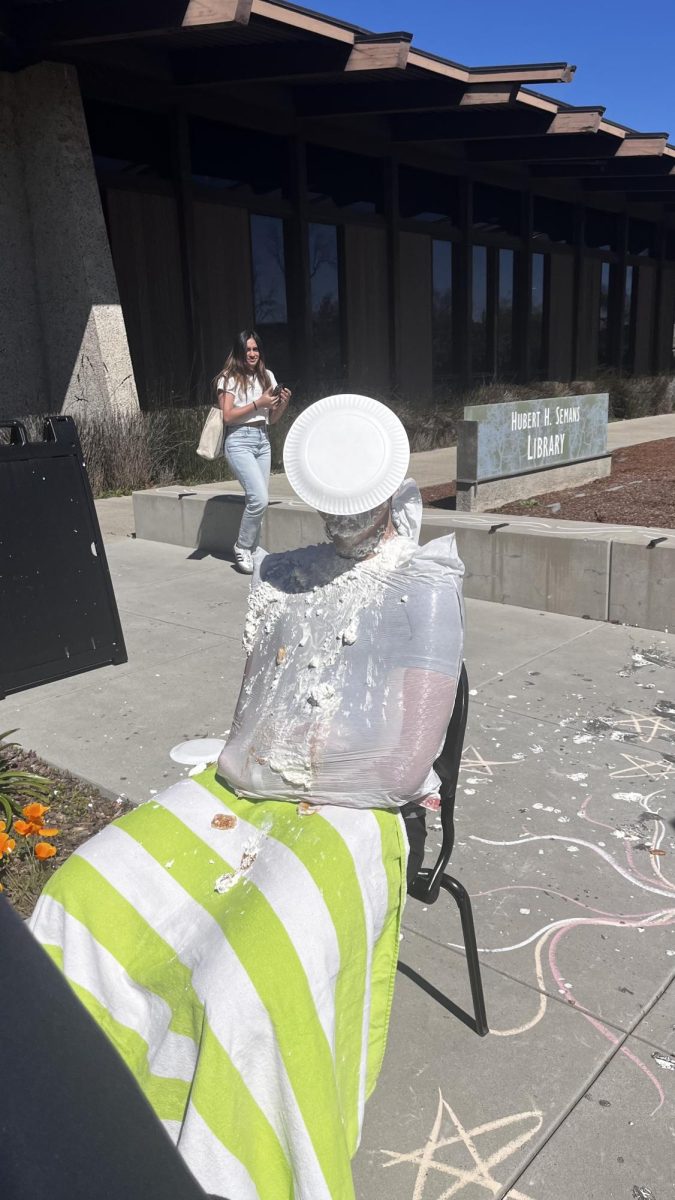 A student in the midst of getting pied. Photo by Jean-Pierre Mouloudj.
