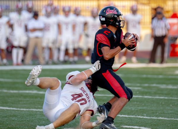 QB Jayden Macedo evades a sack during the Owls' 40-29 win over Sierra.