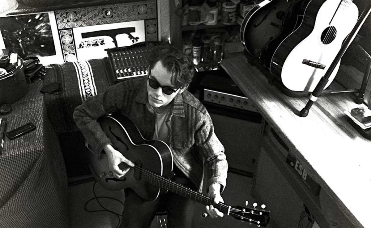 Sean Biggar in his home studio, wielding one of his trusty guitars.